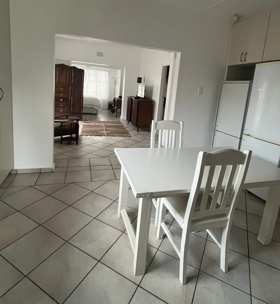Dining table in the two-bedroom unit looking through to the bedroom