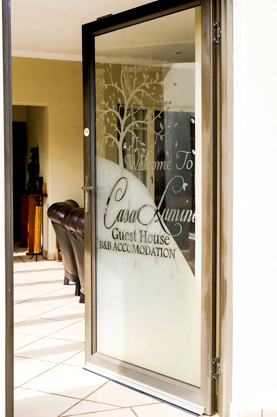 Etched glass front door welcoming guests to Casa Lumini Guest House